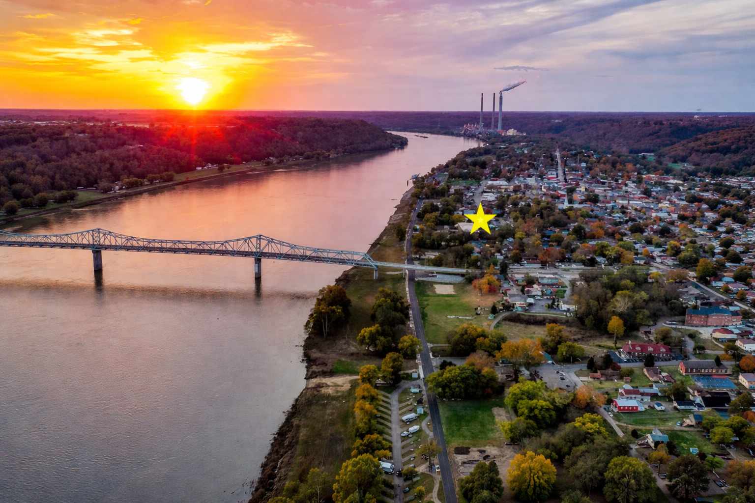Aerial view of Madison, Indiana at sunset with Madison Manor marked by a star