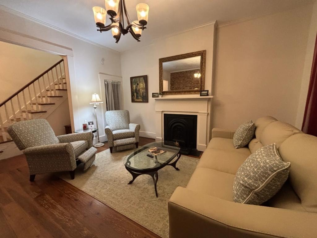 Madison Manor I living room with fireplace and chandelier